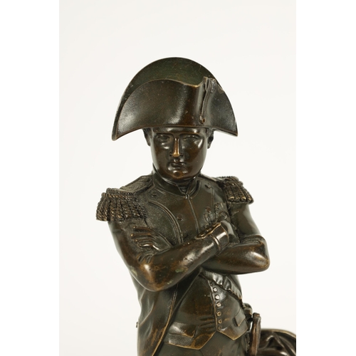 738 - A 19TH CENTURY BRONZE SCULPTURE OF NAPOLEON modelled standing by a draped pillar (23.5cm high)