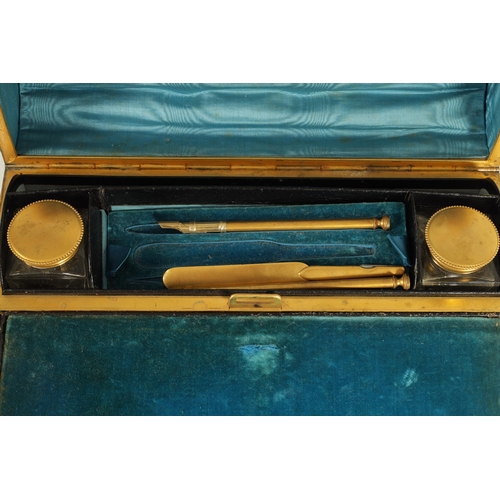 740 - A 19TH CENTURY GILT BRONZE WRITING SLOPE decorated with Tiger's Eye cabochons and embossed strap wor... 