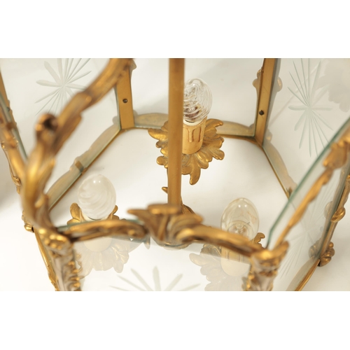 747 - A PAIR OF 19TH CENTURY GILT BRASS HANGING HALL LANTERNS with leaf cast branchwork hexagonal frames w... 