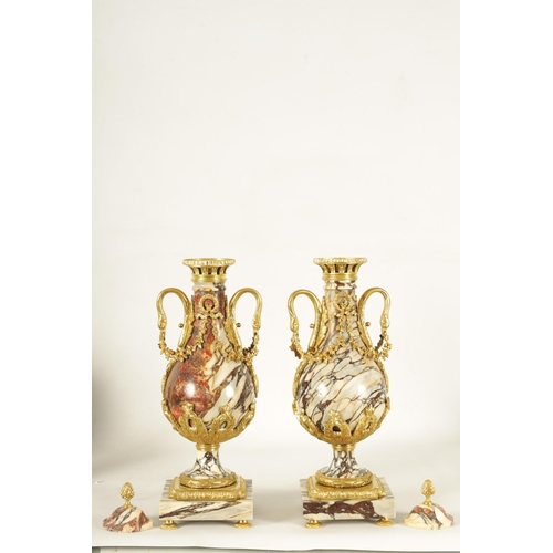 748 - A LARGE PAIR OF LATE 19TH CENTURY ORMOLU MOUNTED ROUGE MARBLE CASSOLETTES the urns with removable do... 