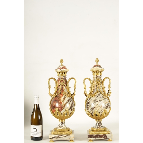 748 - A LARGE PAIR OF LATE 19TH CENTURY ORMOLU MOUNTED ROUGE MARBLE CASSOLETTES the urns with removable do... 