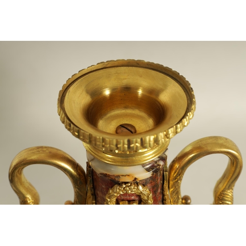 748 - A LARGE PAIR OF LATE 19TH CENTURY ORMOLU MOUNTED ROUGE MARBLE CASSOLETTES the urns with removable do... 