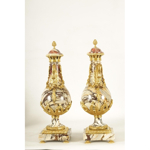 748 - A LARGE PAIR OF LATE 19TH CENTURY ORMOLU MOUNTED ROUGE MARBLE CASSOLETTES the urns with removable do... 