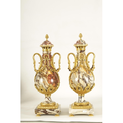 748 - A LARGE PAIR OF LATE 19TH CENTURY ORMOLU MOUNTED ROUGE MARBLE CASSOLETTES the urns with removable do... 