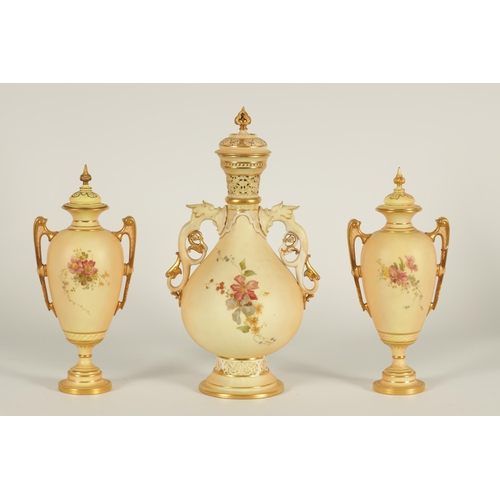 77 - AN ORNATE ROYAL WORCESTER GILT AND IVORY GROUND SCROLLED TWO-HANDLED CABINET VASE AND COVER of bulbo... 