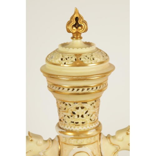 77 - AN ORNATE ROYAL WORCESTER GILT AND IVORY GROUND SCROLLED TWO-HANDLED CABINET VASE AND COVER of bulbo... 