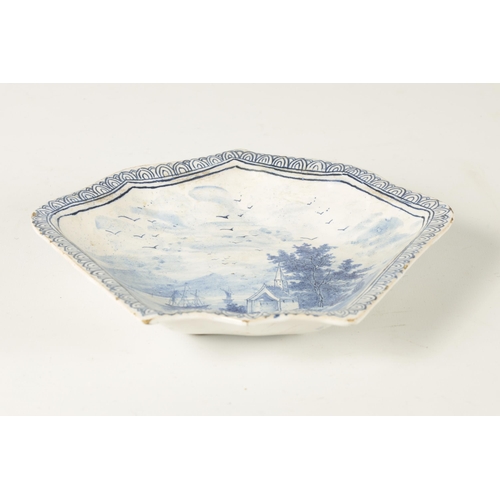 81 - AN 18TH/19TH CENTURY DELFT BLUE AND WHITE SHAPED SHALLOW DISH with lake and landscape centre depicti... 