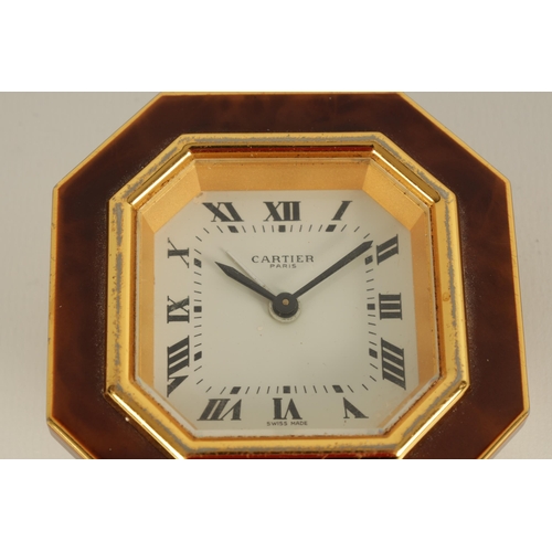 928 - A VINTAGE CARTIER OCTAGONAL GILT AND ENAMEL DESK CLOCK with winding movement with alarm function, an... 