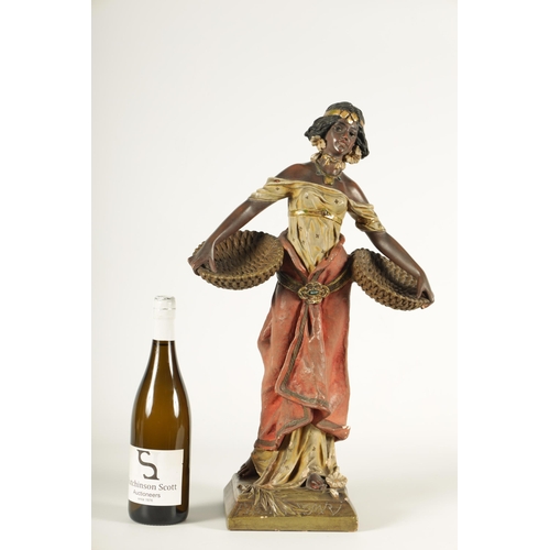 93 - A 20TH CENTURY URIELA TERRACOTTA POLYCHROME FIGURE finely modelled and coloured depicting a standing... 