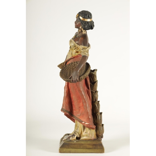 93 - A 20TH CENTURY URIELA TERRACOTTA POLYCHROME FIGURE finely modelled and coloured depicting a standing... 