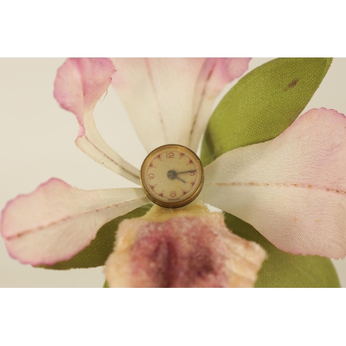 932 - A VINTAGE NOVELTY FLOWER CLOCK modelled as an orchid with watch dial linked to a spring-driven movem... 