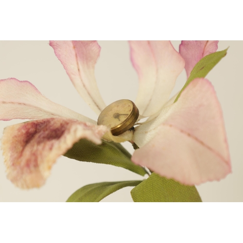 932 - A VINTAGE NOVELTY FLOWER CLOCK modelled as an orchid with watch dial linked to a spring-driven movem... 