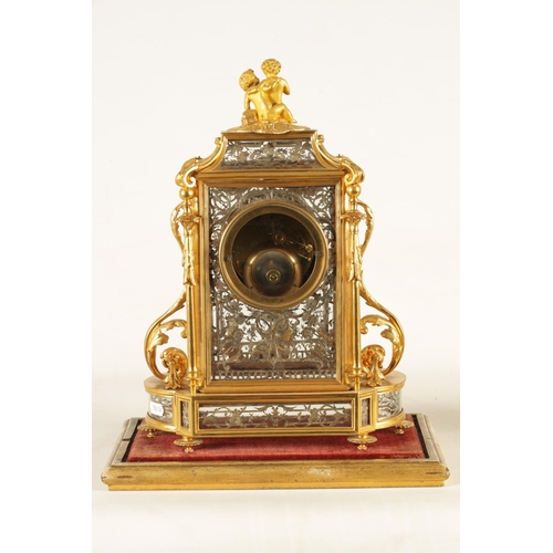 951 - A LATE 19TH CENTURY FRENCH GLAZED ORMOLU MANTEL CLOCK The case surmounted by two ormolu cherubs abov... 