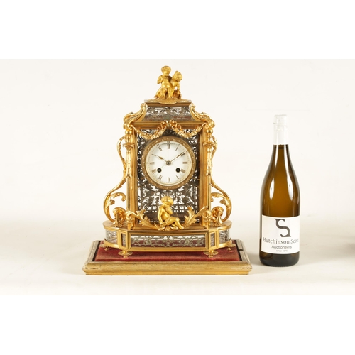 951 - A LATE 19TH CENTURY FRENCH GLAZED ORMOLU MANTEL CLOCK The case surmounted by two ormolu cherubs abov... 