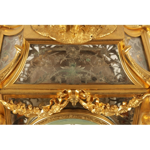 951 - A LATE 19TH CENTURY FRENCH GLAZED ORMOLU MANTEL CLOCK The case surmounted by two ormolu cherubs abov... 