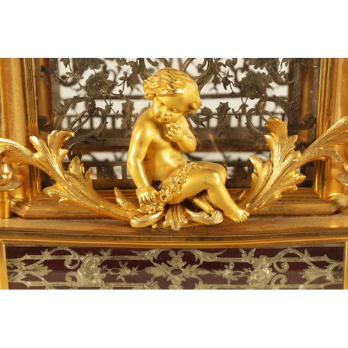 951 - A LATE 19TH CENTURY FRENCH GLAZED ORMOLU MANTEL CLOCK The case surmounted by two ormolu cherubs abov... 