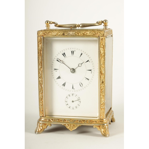 958 - A LATE 19TH CENTURY FRENCH REPEATING CARRIAGE CLOCK the gilt brass foliate relief work case with bev... 