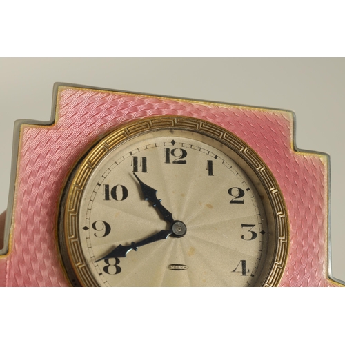 962 - AN ART DECO SILVER AND GUILLOCHE ENAMEL STRUT CLOCK the shaped case with an engraved gilt circular b... 