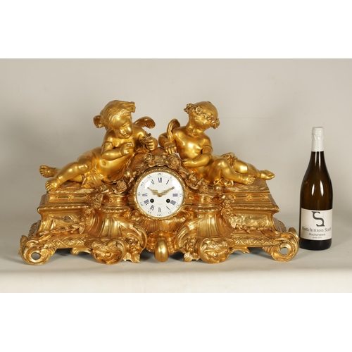 982 - A LARGE 19TH CENTURY FRENCH FIGURAL ORMOLU MANTEL CLOCK surmounted by two cherubs on a leaf work bas... 