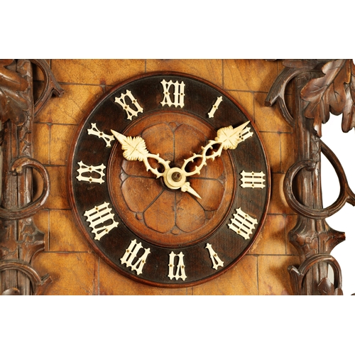 992 - A LARGE 19TH CENTURY THREE-TRAIN MUSICAL CUCKOO CLOCK the carved leafwork case surmounted by an eagl... 