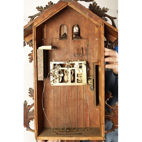 992 - A LARGE 19TH CENTURY THREE-TRAIN MUSICAL CUCKOO CLOCK the carved leafwork case surmounted by an eagl... 