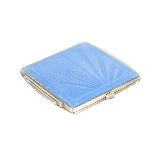 303 - AN ART DECO SILVER AND GUILLOCHE ENAMEL LADIES COMPACT with a wavy fanned design to the top opening ... 