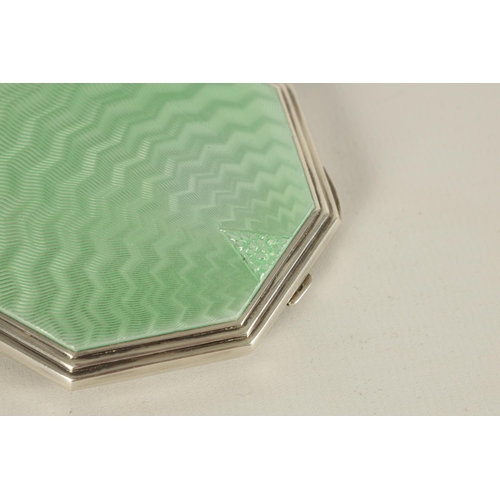 306 - AN ART DECO OCTAGONAL SILVER AND GUILLOCHE ENAMEL POWDER COMPACT with terminating wave pattern centr... 