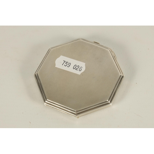 306 - AN ART DECO OCTAGONAL SILVER AND GUILLOCHE ENAMEL POWDER COMPACT with terminating wave pattern centr... 