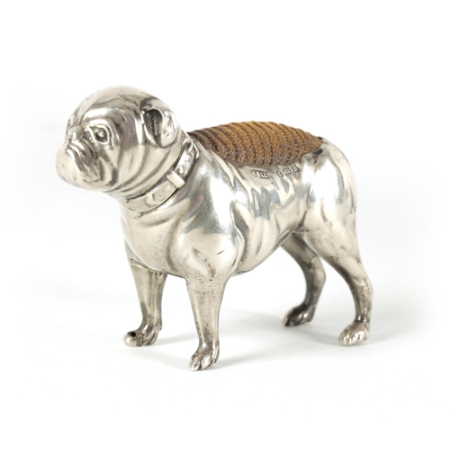 340 - A VICTORIAN SMALL SILVER PIN CUSHION IN THE FORM OF A BULLDOG modelled in a standing position with c... 