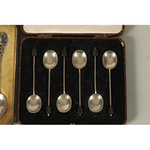 350 - A CASED SET OF EDWARD VII SILVER AND ENAMELLED TEASPOONS with flattened filigree handles depicting f... 