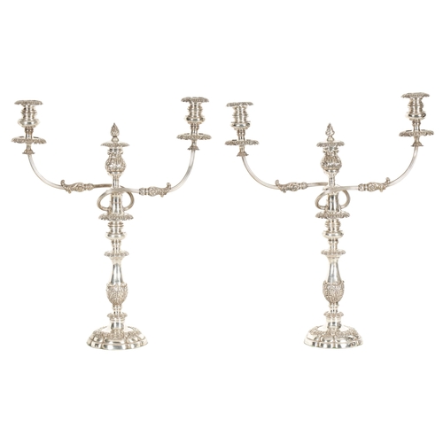 357 - A LARGE PAIR OF GEORGE IV SHEFFIELD PLATE TWO BRANCH CANDELABRA decorated with acanthus leaves and f... 