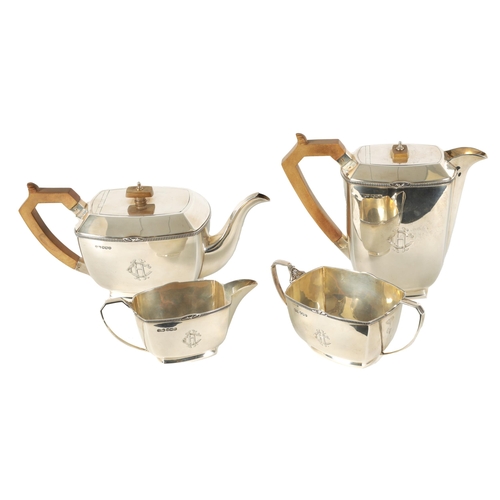 360 - A GEORGE VI ART DECO STYLE FOUR PIECE SILVER TEA SERVICE of plain rectangular rounded footed form wi... 