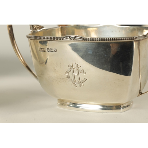 360 - A GEORGE VI ART DECO STYLE FOUR PIECE SILVER TEA SERVICE of plain rectangular rounded footed form wi... 