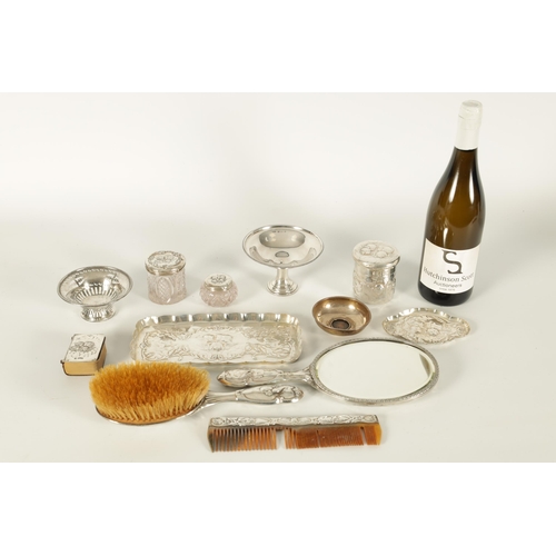 366 - AN ART NOVEAU SILVER NINE PIECE DRESSING TABLE SET decorated with winged chuerbs hallmarked William ... 