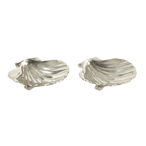 371 - A NEAR PAIR OF ELIZABETH II IRISH SILVER SCALLOP DISHES each with fluted bowl and naturalistic textu... 