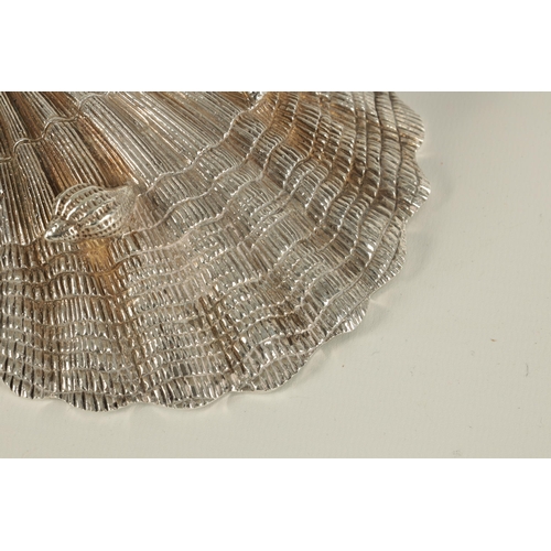 371 - A NEAR PAIR OF ELIZABETH II IRISH SILVER SCALLOP DISHES each with fluted bowl and naturalistic textu... 