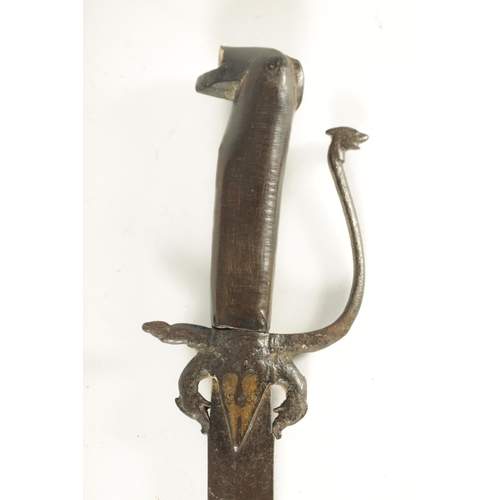 394 - AN 18TH CENTURY SRI LANKAN RHINOCEROS HORN HANDLED KASTANE SWORD the handle formed as a primitively ... 