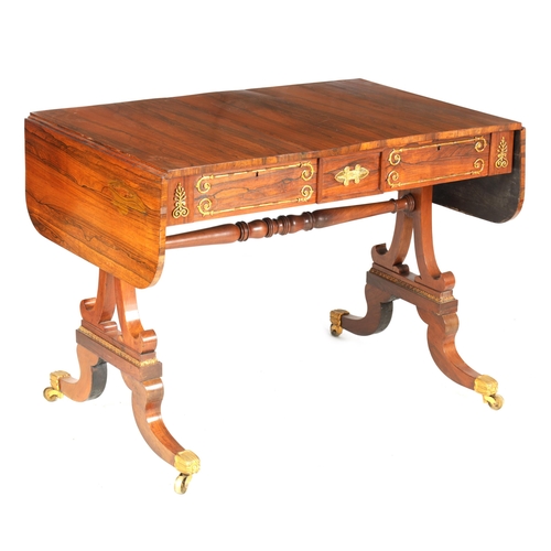 1198 - A REGENCY BRASS MOUNTED FIGURED ROSEWOOD SOFA TABLE with fold-down ends enclosing two frieze drawers... 