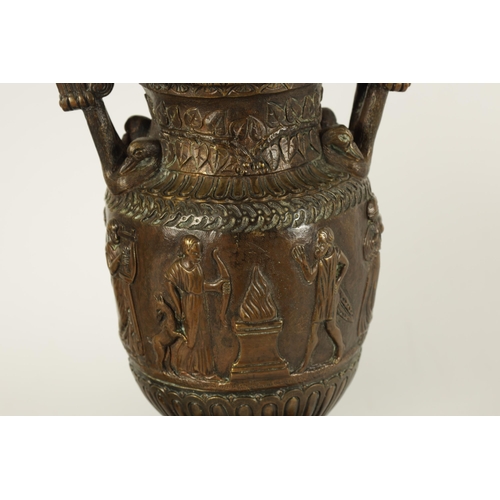 752 - A PAIR OF 19TH CENTURY FRENCH BRONZE ROMANESQUE TWO-HANDLED URNS on stepped black slate bases. (29cm... 