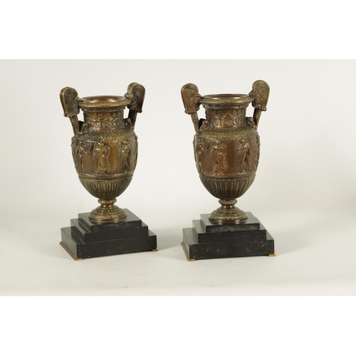 752 - A PAIR OF 19TH CENTURY FRENCH BRONZE ROMANESQUE TWO-HANDLED URNS on stepped black slate bases. (29cm... 