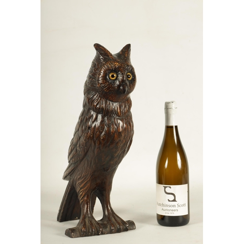 758 - A LATE 19TH CENTURY LIFE SIZE COLD PAINTED CAST IRON OWL with inset amber glass eyes perched on a ba... 