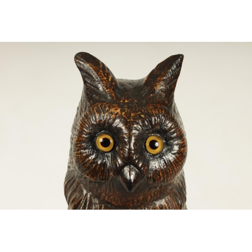 758 - A LATE 19TH CENTURY LIFE SIZE COLD PAINTED CAST IRON OWL with inset amber glass eyes perched on a ba... 