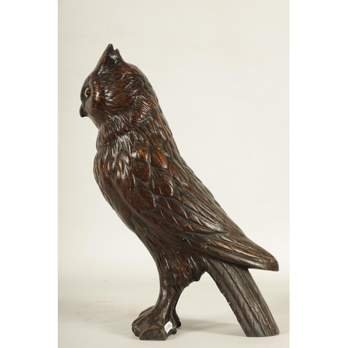 758 - A LATE 19TH CENTURY LIFE SIZE COLD PAINTED CAST IRON OWL with inset amber glass eyes perched on a ba... 