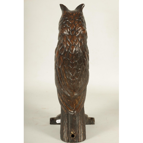 758 - A LATE 19TH CENTURY LIFE SIZE COLD PAINTED CAST IRON OWL with inset amber glass eyes perched on a ba... 