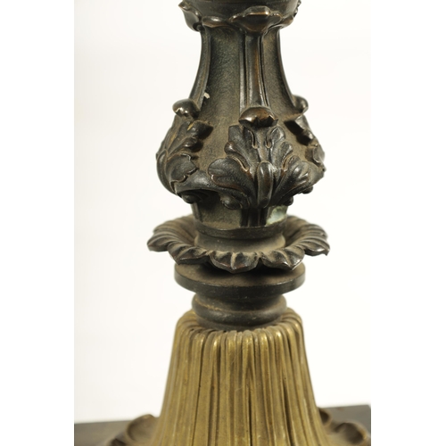 786 - A REGENCY BRONZE AND ORMOLU TABLE LAMP with acanthus leaf mouldings and masked centre raised on a sq... 