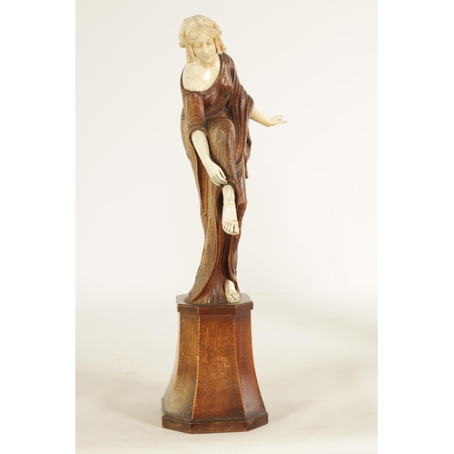 787 - LEONIE BOEHM-HENNES. AN ART NOUVEAU MIXED MEDIA WALNUT AND IVORY CARVED SCULPTURE OF A YOUNG LADY th... 