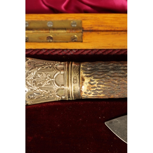 790 - A LATE 19TH CENTURY BOXED SILVER MOUNTED STAG HORN CARVING SET the inlaid oak case with velvet and s... 