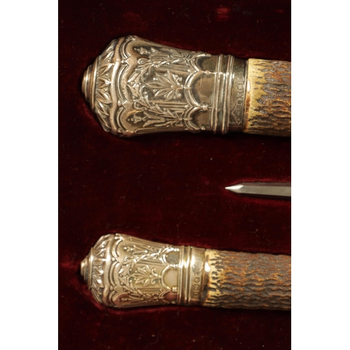 790 - A LATE 19TH CENTURY BOXED SILVER MOUNTED STAG HORN CARVING SET the inlaid oak case with velvet and s... 