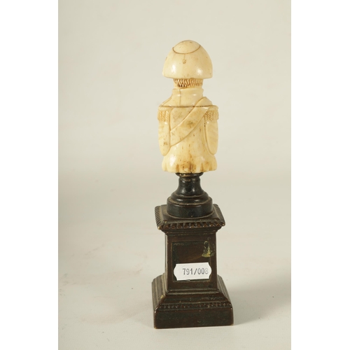 791 - A 19TH CENTURY FRENCH BRONZE AND BONE CARVED SCULPTURE Modelled as Napoleon Bonaparte raised on a pa... 