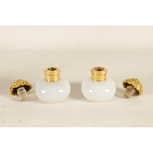 793 - A PAIR OF EARLY 19TH CENTURY FRENCH ORMOLU MOUNTED WHITE OPALINE GLASS PERFUME BOTTLES of bulbous fo... 